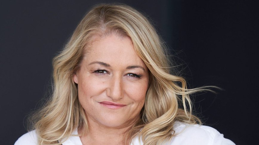 Raelle Tucker's Magical World Leap: TV Genius Spins Debut Novel with Crown